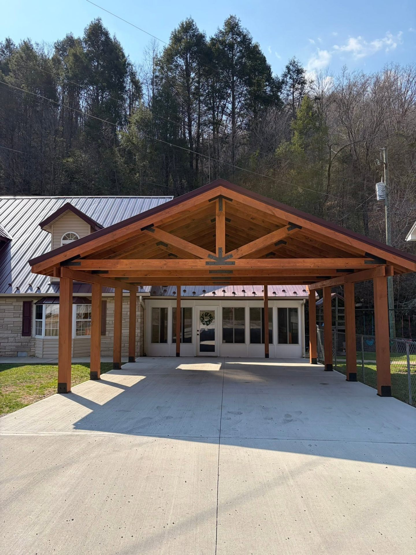 Custom timber-frame carport with metal roof in Jenkins, KY